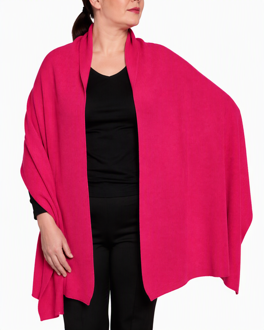 English Rib Blanket Shawl in Flare, a vivid fuchsia Merino wool rib knit, draped open over the shoulders